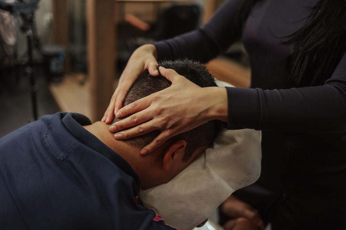 Man receiving a relaxing head and neck massage