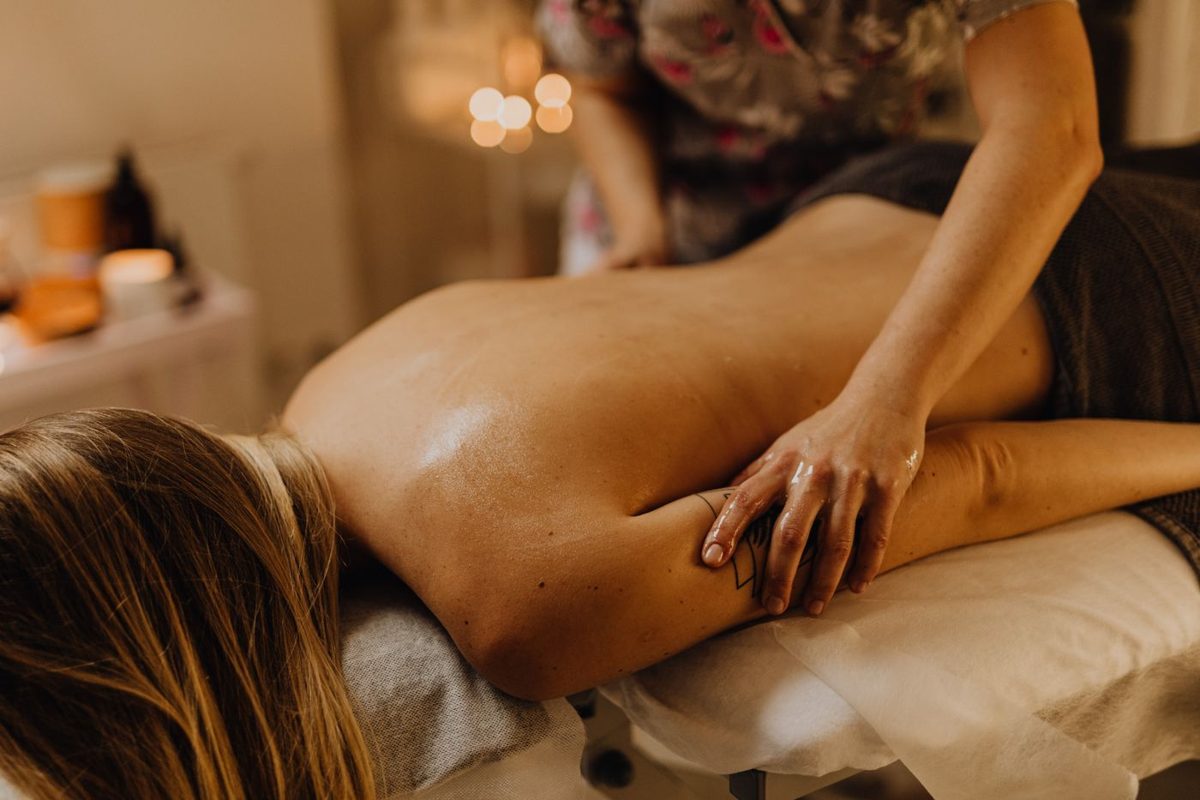 Guest relaxing during a warm, soothing back massage